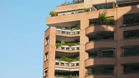 Modern residential building with greenery covered terraces and balconies with modern urban architecture, eco-friendly biophilic design and luxury living, Milan, Italy. Vertical landscaping - Powered by Shutterstock - Get 15% off with code: PIKWIZARD15