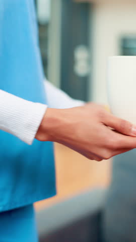 Hands, caregiver and coffee with old woman at house for breakfast, snack and assistance. Smile, senior person and volunteer serving drink with biscuits, tea time and healthcare support for retirement