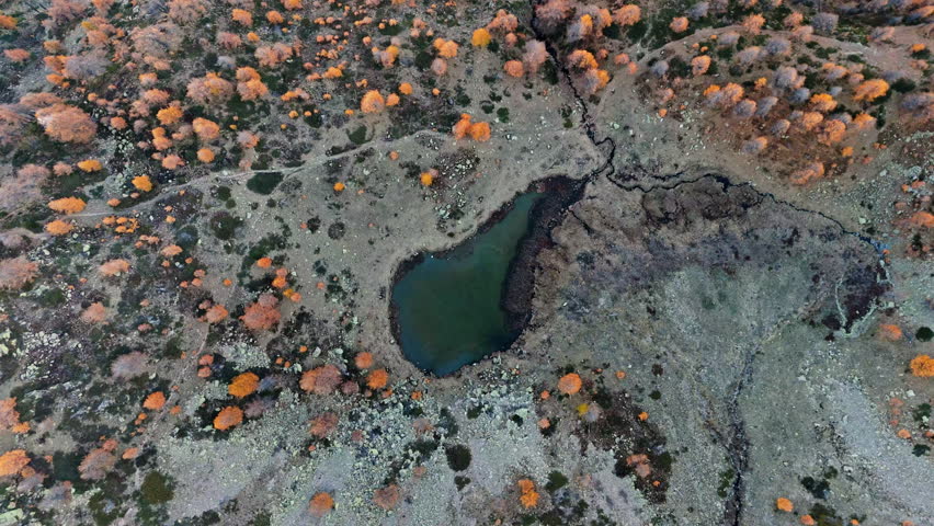 Aerial view of Mouton Lakes with orange autumn trees and rocky terrain