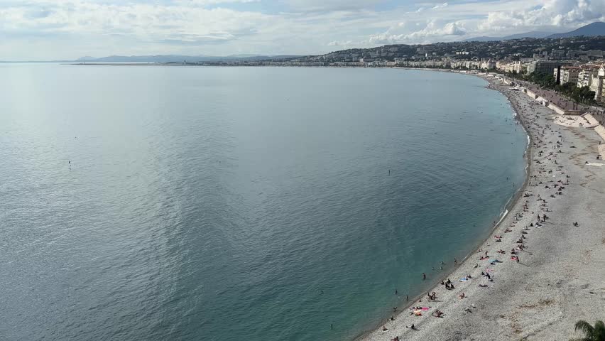 Promenade des Anglais, or Promenade of the English, sea beach and Old Town in Nice, France, view from the Castle Hill while panning in autumn sunny day
