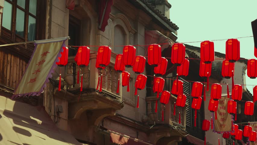 Dense Display of Red Chinese Lanterns Hanging Across Street