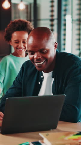 Hug, laptop and search with African family in home dining room for holiday or vacation planning. Computer, excited or pointing with kids and parents in apartment together for online booking of hotel