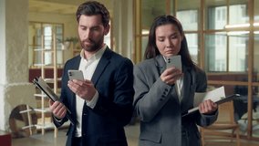 Multiethnic office coworkers Korean businesswoman Caucasian businessman using mobile phone digital teamwork business productivity connection networking collaboration smartphones app online work focus - Powered by Shutterstock - Get 15% off with code: PIKWIZARD15