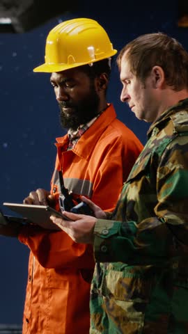 Vertical Video Soldier perform escort duty with walkie talkie on maritime vessel near offshore drilling rig, using radio communication to monitor operations and safeguard employees from security risks