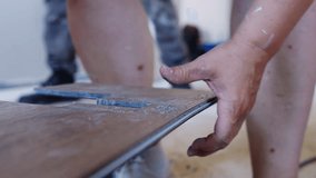 Couple Renovates Home Installing Vinyl Lock Laminate Flooring. Woman And Man Collaborate On DIY Home Improvement Project Laying Laminate With Click-Lock Connection System. - Powered by Shutterstock - Get 15% off with code: PIKWIZARD15