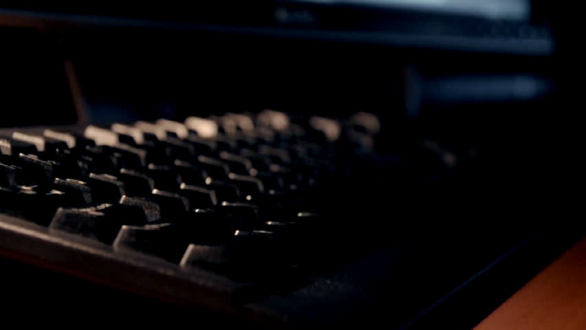 A man types on a computer keyboard.