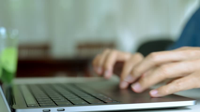 close-up female hand touching touchpad on a laptop computer	