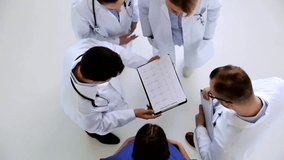 Group of doctors reviewing a cardiogram at the hospital, highlighting cardiology, healthcare teamwork, medical consultation, and patient care. - Powered by Shutterstock - Get 15% off with code: PIKWIZARD15