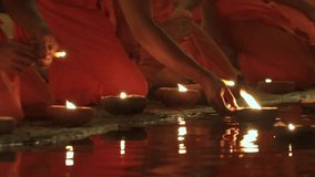 Loi Krathong and Yi Peng festival in Chiang Mai, Thailand, with Buddhist monks and locals releasing glowing lanterns into the night sky. - Powered by Shutterstock - Get 15% off with code: PIKWIZARD15