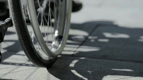 Low-angle view of a differently-abled man using a wheelchair outdoors, highlighting mobility, independence, accessibility, and inclusive lifestyle. - Powered by Shutterstock - Get 15% off with code: PIKWIZARD15