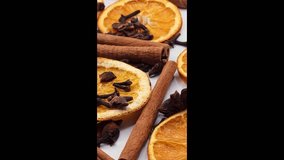Herbal winter tea ingredients - cinnamon, anise, carnation and slices of dry citrus. Healthy seasonal beverage, close-up, vertical view - Powered by Shutterstock - Get 15% off with code: PIKWIZARD15