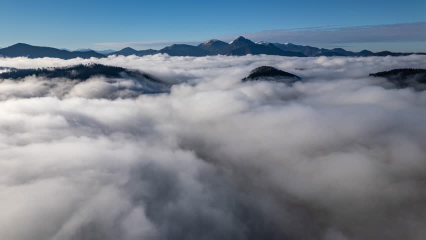 Foggy Clouds Flowing Peacefully in Misty Mountain Valley at Sunrise Aerial View