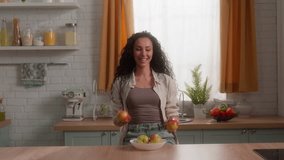 Happy smiling Hispanic woman juggling apples having fun at kitchen healthy food Latina female laughing joyful girl playing throwing fruits enjoying vegetarian nutrition delivery diet home health care - Powered by Shutterstock - Get 15% off with code: PIKWIZARD15