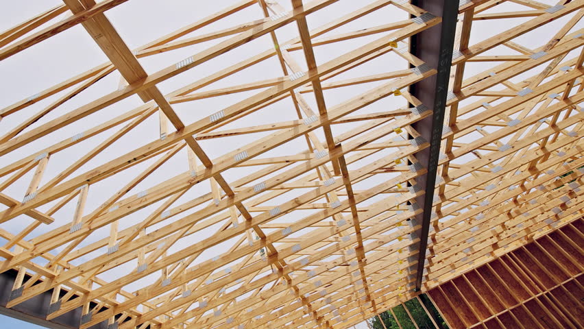 Detailed view of wooden beams forming structure of roof rafters beams under construction