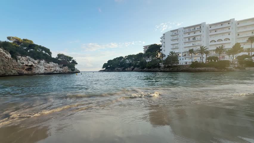Sunset on Cala Ferrera beach in Cala D'Or village in Mallorca, Spain panoramic view.