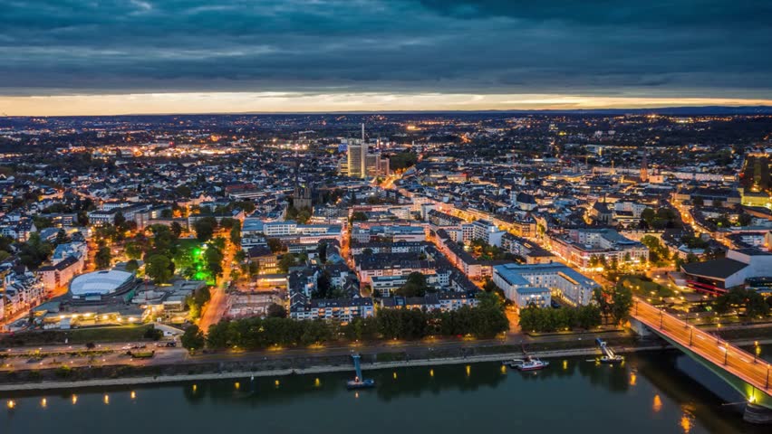 Aerial View of a City at Twilight with River and Bridge