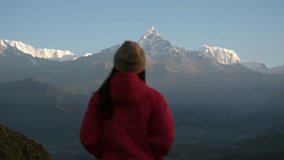 Blurred rear view of a woman traveler looking at Machapuchare peak, Annapurna mountain range in Pokhara , Nepal - Powered by Shutterstock - Get 15% off with code: PIKWIZARD15