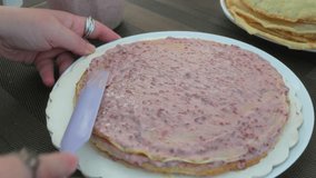 Spreading Berry-filled Cream Onto Layered Crepe Cake Using Spatula. closeup shot - Powered by Shutterstock - Get 15% off with code: PIKWIZARD15