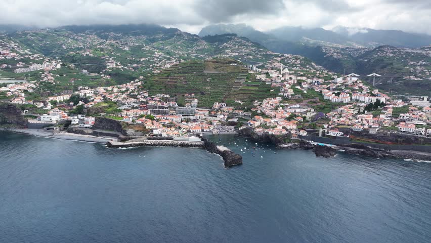 Aerial establishing view toward seaside Câmara de Lobos on Madeira south coast