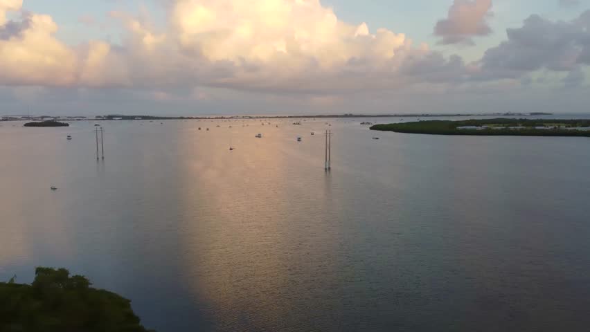 Panoramic aerial view of sunrise over Sand Point, Fleming Key, Dredgers Key, and Garrison Bight Mooring Field in Key West, Florida, showcasing wide coastal scenery from above.