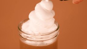 Smooth whipped cream dispensed onto creamy chocolate milkshake, close-up, warm lighting, steady camera - Powered by Shutterstock - Get 15% off with code: PIKWIZARD15