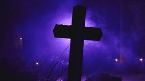 A dark cross silhouetted against eerie purple fog, with delicate spider webs visible around the edges, creating a moody, mystical atmosphere. - Powered by Shutterstock - Get 15% off with code: PIKWIZARD15