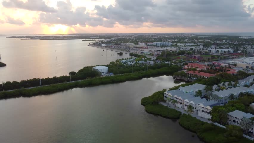 sunrise view over Sand Point in Key West, Florida, capturing golden early-morning light reflecting on calm water and the coastal landscape from above