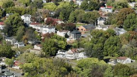 Two-story and three story houses in Americans. Neighborhood. Sunny day in fall season with colored trees. Aerial view. Lynchburg, Virginia. Wide shot. - Powered by Shutterstock - Get 15% off with code: PIKWIZARD15