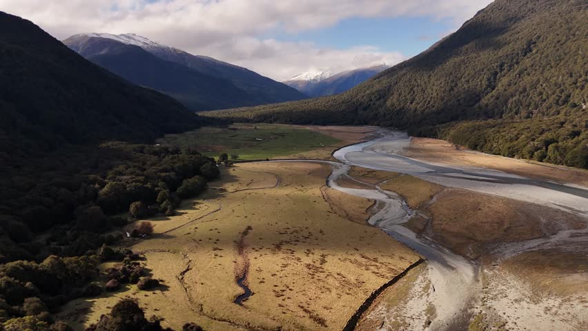 River flowing through valley in Mount Aspiring National Park, South Island, New Zealand. Aerial