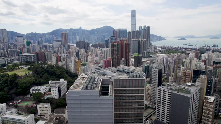 Hong Kong Aerial view over the Kowloon district looking towards the Central District on a beautiful sunny day in 4K
