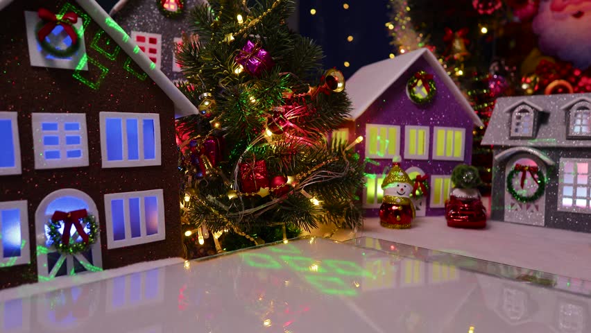 An orange car with a Christmas tree on the roof drives into the center of the town and stops