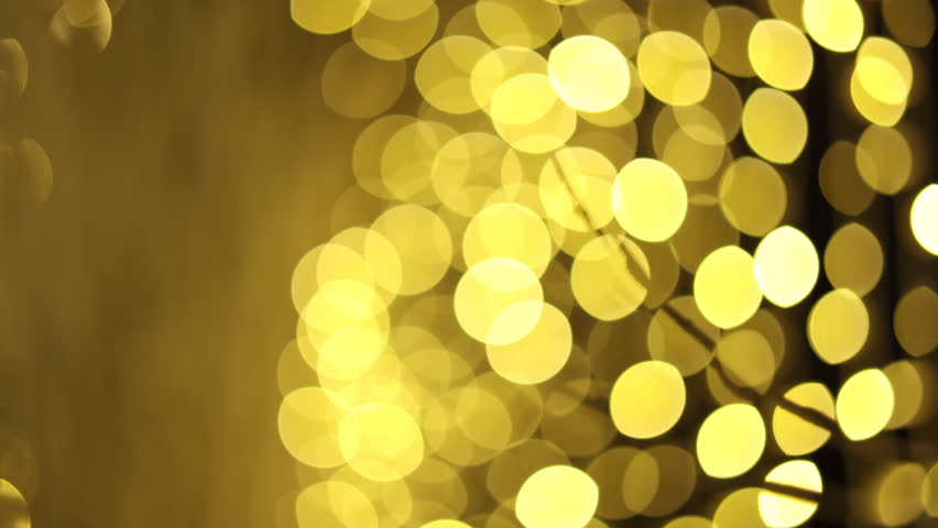 Festive blurred golden New Year lights background. Abstract sparkling bokeh, holiday background with golden glow. Perfect for Christmas titles, winter celebration, festive slideshow, holiday greeting 