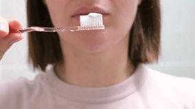 Woman brushes her teeth with toothbrush with toothpaste close-up. - Powered by Shutterstock - Get 15% off with code: PIKWIZARD15