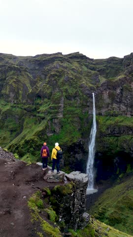 Explore the breathtaking beauty of Mulagljufur Canyon in Iceland, featuring lush green cliffs and a striking waterfall.