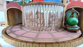 A Christmas toy train riding on rails around a Christmas tree. New Year's mood. Christmas background.  - Powered by Shutterstock - Get 15% off with code: PIKWIZARD15