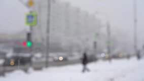 Blurred street of city with people and road with cars and bus in snowfall in winter. Urban winter cityscape with snowstorm in defocus. Weather concept - Powered by Shutterstock - Get 15% off with code: PIKWIZARD15