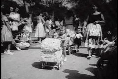 1950s - A parade of babies and infants in their Sunday best. A diaper derby is shown as well.