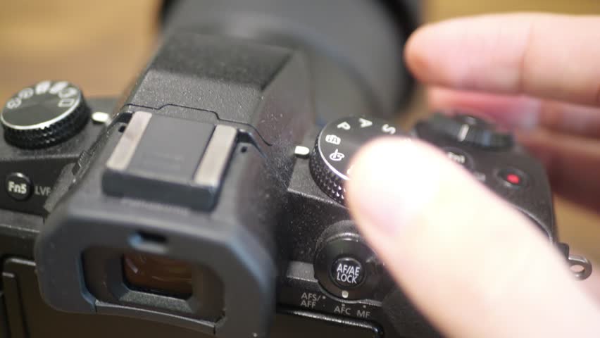 Full-Frame Digital Camera Mode Dial Rotating with Precise Click Feedback, Demonstrating Professional Photography Equipment Control, Tactile Interface Detail, Creative Production Workflow Moment - Powered by Shutterstock - Get 15% off with code: PIKWIZARD15