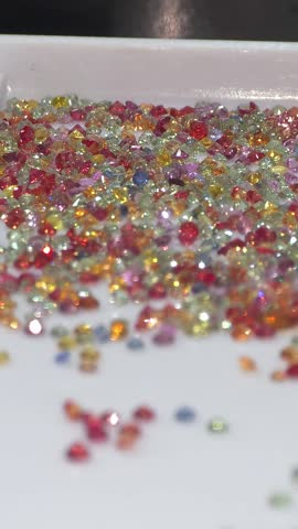 Colorful loose gemstone sparkling on white tray. Jewelry and gems business of selling