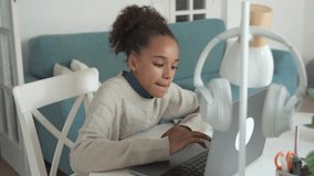 Primary middle school African American Student child girl study use laptop. Distance learning online education. School girl type at home with digital tablet computer and doing school homework. - Powered by Shutterstock - Get 15% off with code: PIKWIZARD15