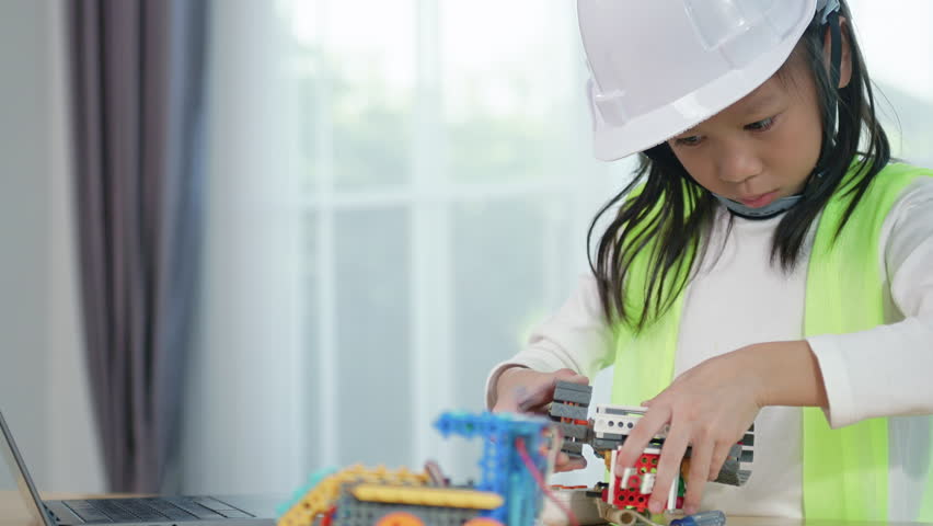 Young girl engineer working on robotics project in a STEM education class. child is focused on assembling and learning about a small robot or electronic project. engineering, innovation, technology.