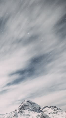Stepantsminda, Georgia. Winter Night Starry Sky With Glowing Stars Over Peak Of Mount Kazbek Covered With Snow. Beautiful Night Georgian Winter Landscape
