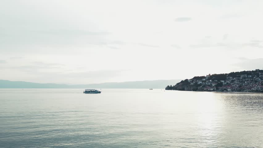 Gorgeous morning over the Ohrid Lake and a ferry sailing across, North Macedonia