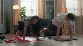 Happy multiracial couple doing sport climbing abs exercise at home cheerful Hispanic woman with Caucasian man training abdominal muscles workout fit together running plank healthy lifestyle family - Powered by Shutterstock - Get 15% off with code: PIKWIZARD15