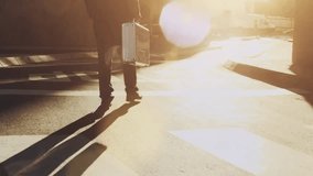 Smooth steadicam shot of an African American businessman walking with a laptop bag and morning coffee through a modern city street at sunrise while commuting to work. - Powered by Shutterstock - Get 15% off with code: PIKWIZARD15