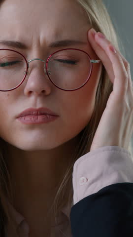 Bad feeling Caucasian business woman in office touching head fever suffering high temperature sick businesswoman girl female touch forehead unwell headache take off glasses massages temples migraine
