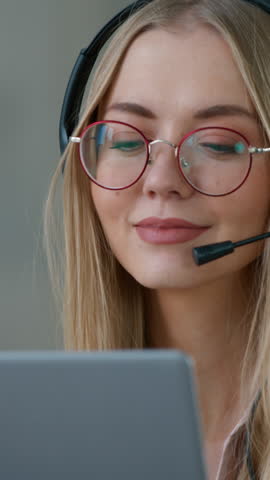Caucasian business woman in headset talking video call with laptop in office girl female businesswoman helpline agent customer service call center help line manager wearing headphones with microphone
