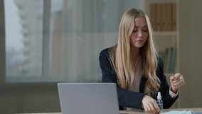 Caucasian business woman in office put on three face medical protective mask funny scared businesswoman female girl employer with laptop worry about pandemic virus coronavirus danger protecting health - Powered by Shutterstock - Get 15% off with code: PIKWIZARD15