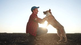 Farmer and his dog play together in field. farming is the concept of caring for pet. a man and his dog are in friendship together. a man and a dog playing lifestyle together in a field. - Powered by Shutterstock - Get 15% off with code: PIKWIZARD15