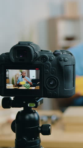 View through camera on african man which recording new video for his vlog showing carton boxes with unknown gifts